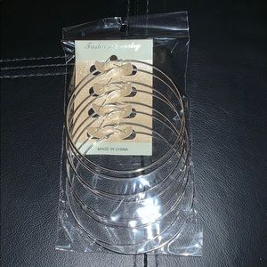 4 pairs of silver hoop earrings.